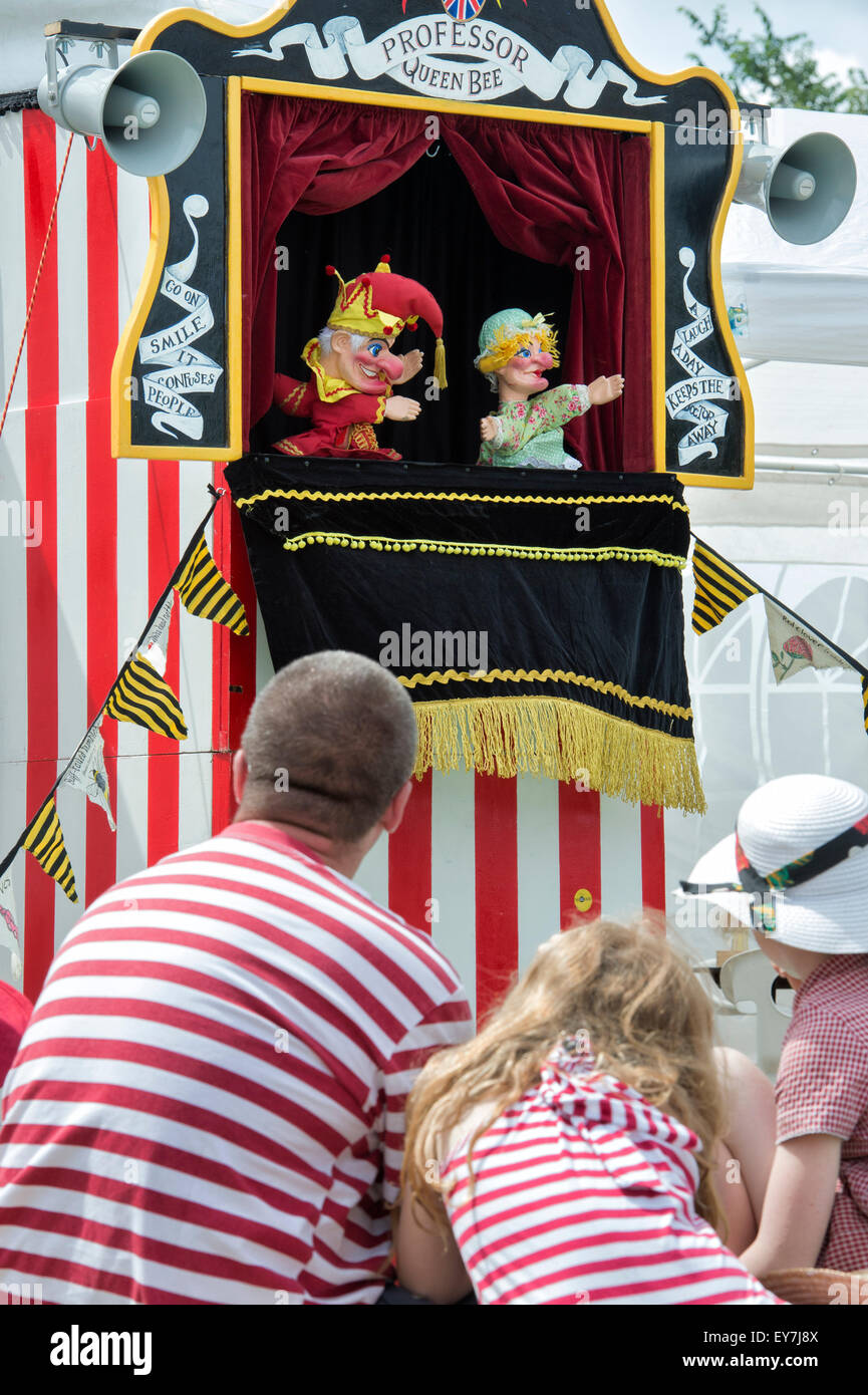 People watching a Punch and Judy Show at the Thames Traditional Boat Festival, Fawley Meadows, Henley On Thames, Oxfordshire, England Stock Photo