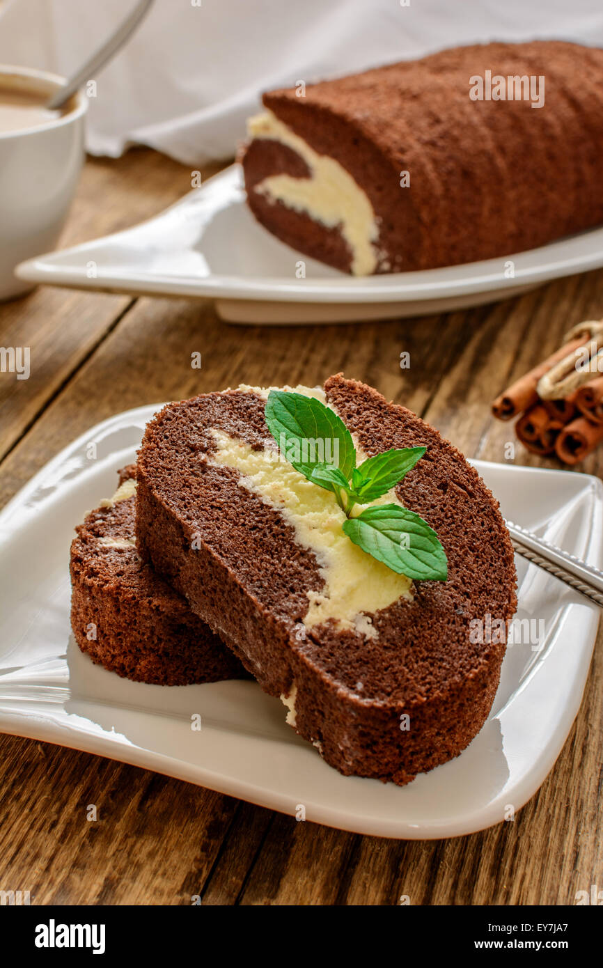 Chocolate roll dessert with coffee on wood table Stock Photo