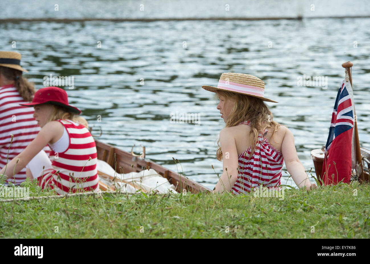 Young girls in red and white stripy clothing at the Thames Traditional Boat Festival, Fawley Meadows, Henley On Thames, Oxfordshire, England Stock Photo