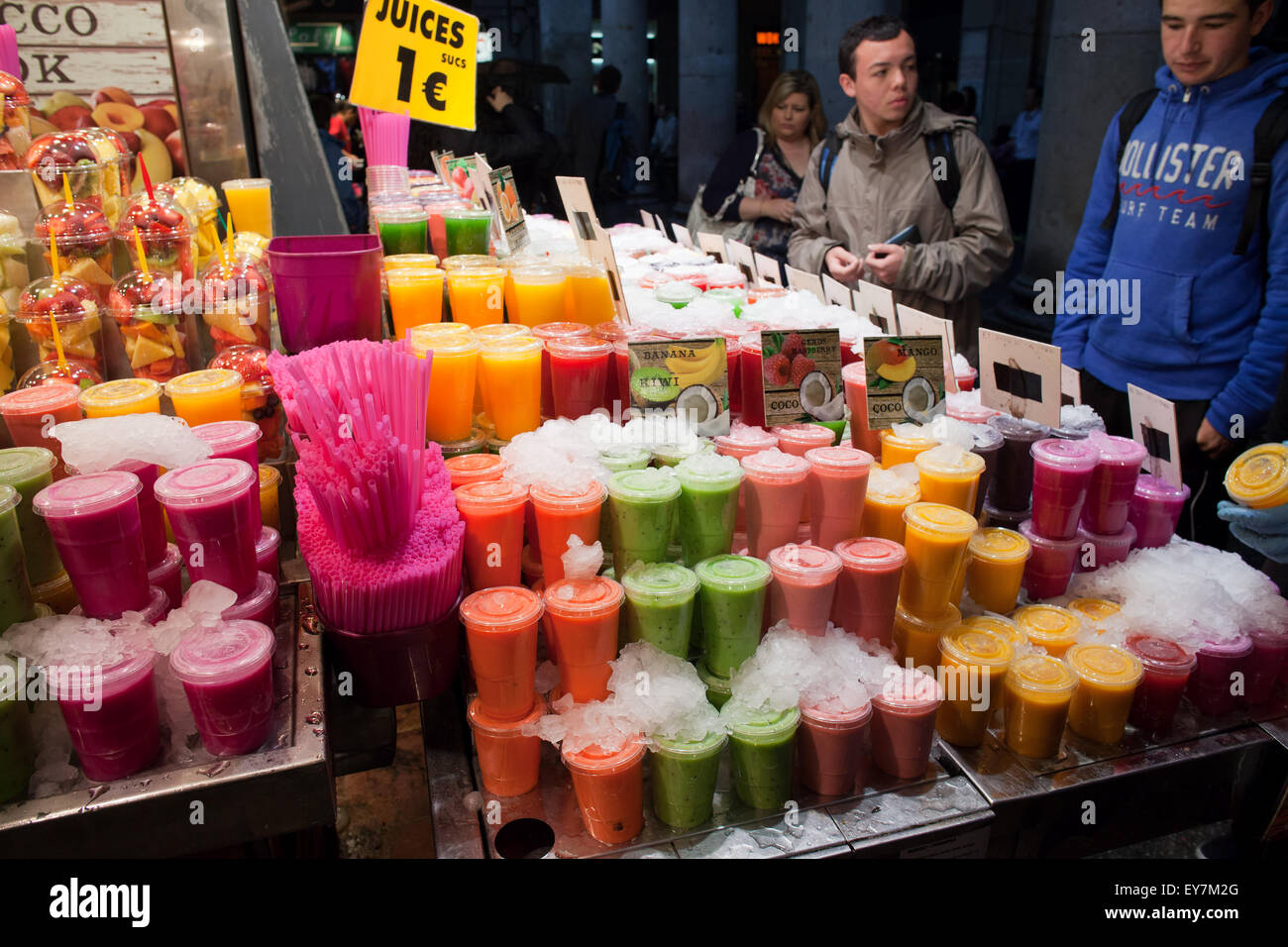Fresh fruit juices in cups in La Boqueria food market in Barcelona