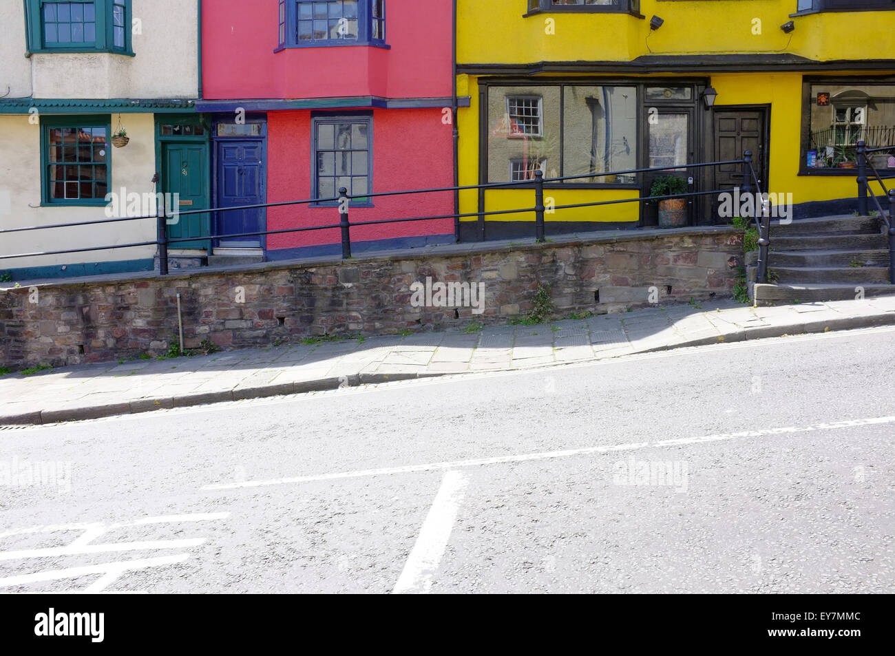 A row of colourful houses on a sloping road in Bristol. Stock Photo