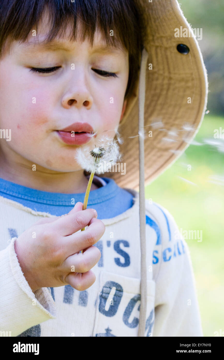 Caucasian Child Boy 6 7 Year Old Boy With Floppy Sunhat Blowing