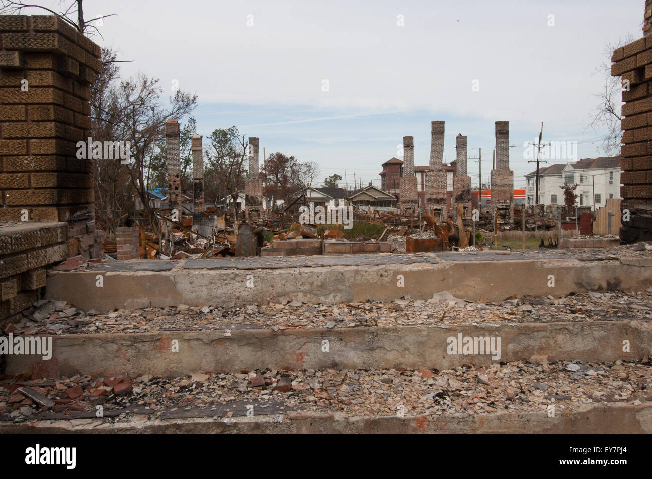 A view city block burned to the ground in the aftermath of Hurricane Katrina in New Orleans.  The chimneys and the slab are all that is left. Stock Photo