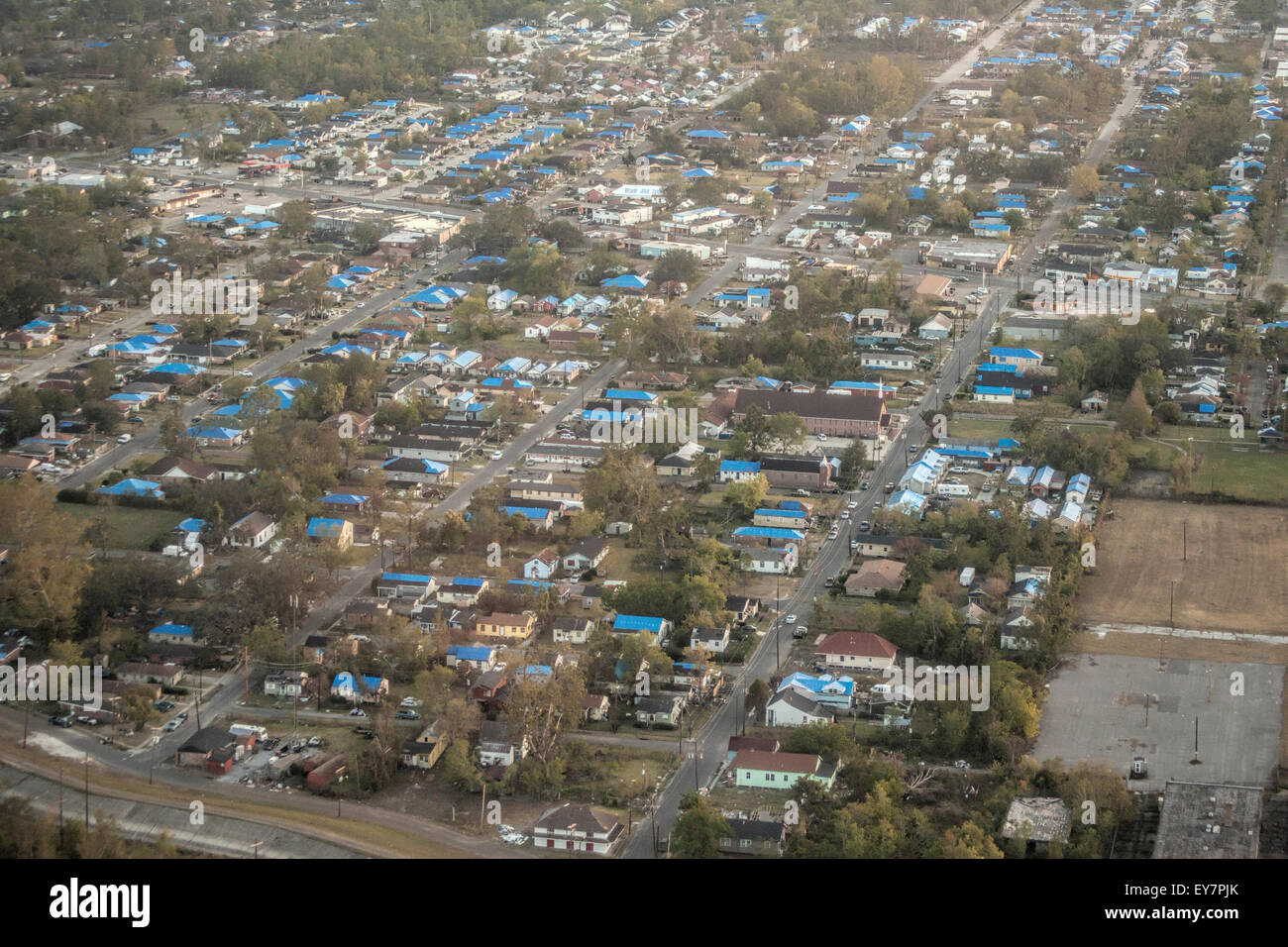 Aerial view of blue FEMA tarps on houses in the wake of Hurricane