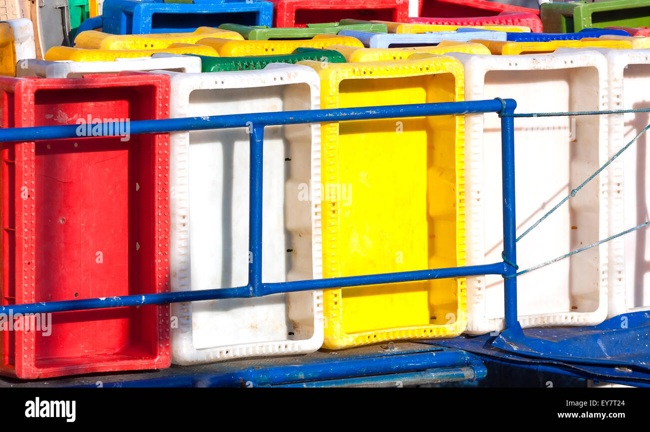 Colorful plastic fish containers in a port. Stock Photo