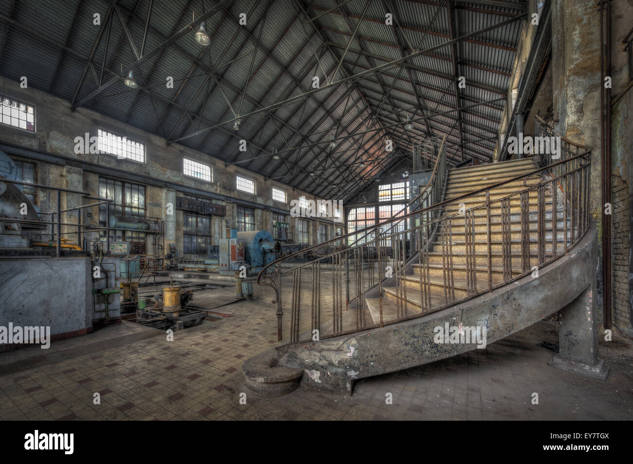 Imposing staircase inside the hall of an abandoned power plant Stock Photo