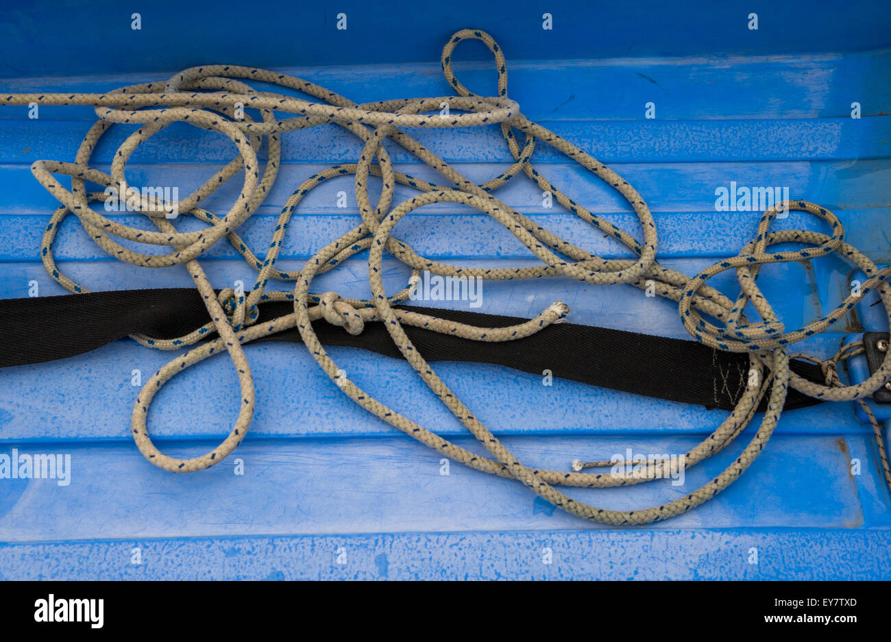 Nylon rope laying in a blue painter boat. Stock Photo