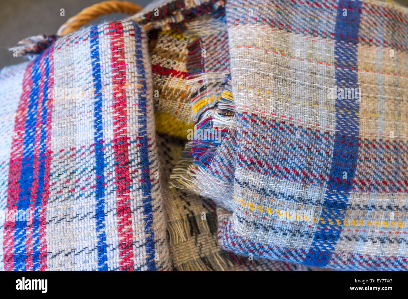 Knitted blankets or sheets in coloured patterns. Stock Photo