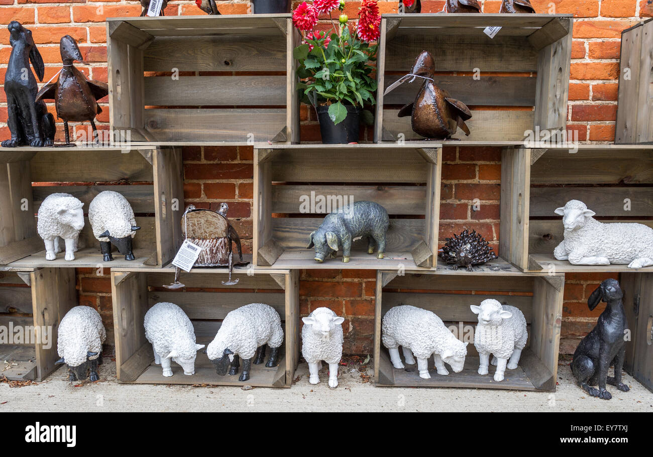 White painted sculptured sheep on display in wooden boxes. Stock Photo