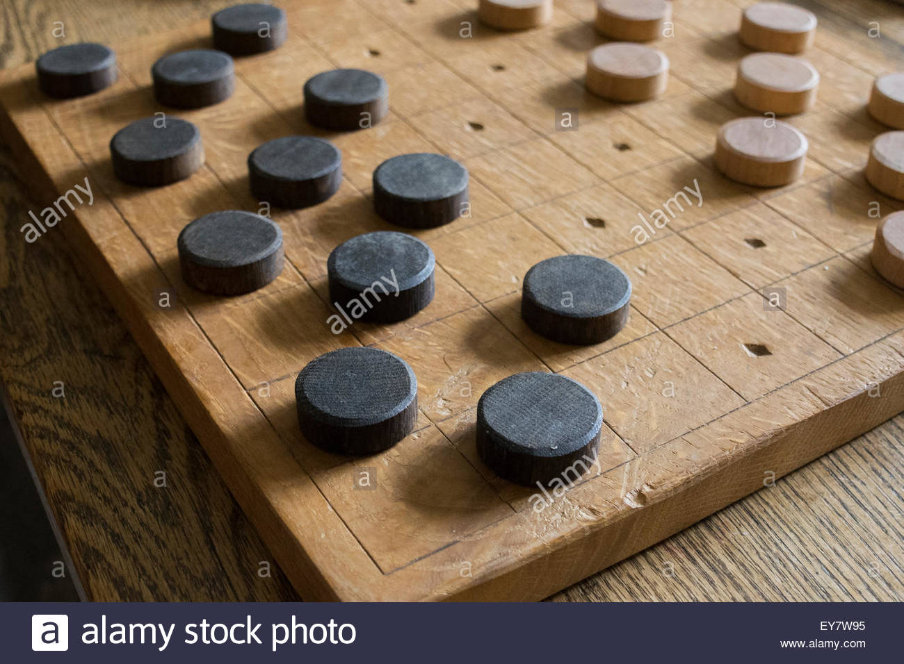 A Wooden Draughts Board And Pieces Resting On Table Stock