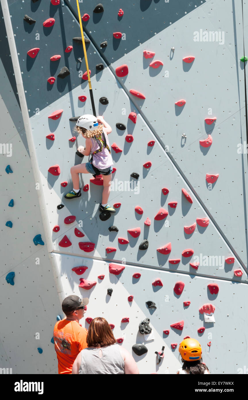 Young girl using a climbing wall in Maggie Daley Park, in northeastern Grant Park, Chicago. Stock Photo