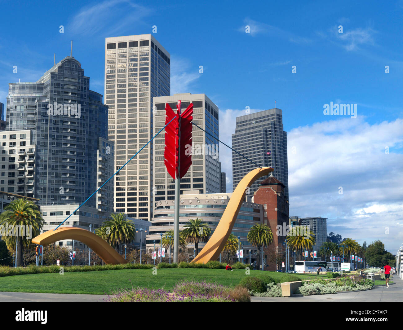 Cupid's Span a giant bow and arrow sculpture on the Embarcadero with Embarcadero Centre and Financial District behind San Francisco California USA Stock Photo