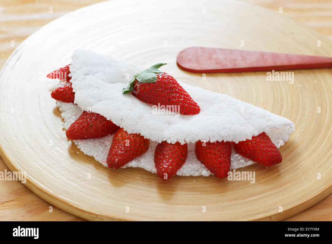 Casabe (bammy, beiju, bob, biju) - flatbread made from cassava (tapioca) with strawberry. Selective focus Stock Photo