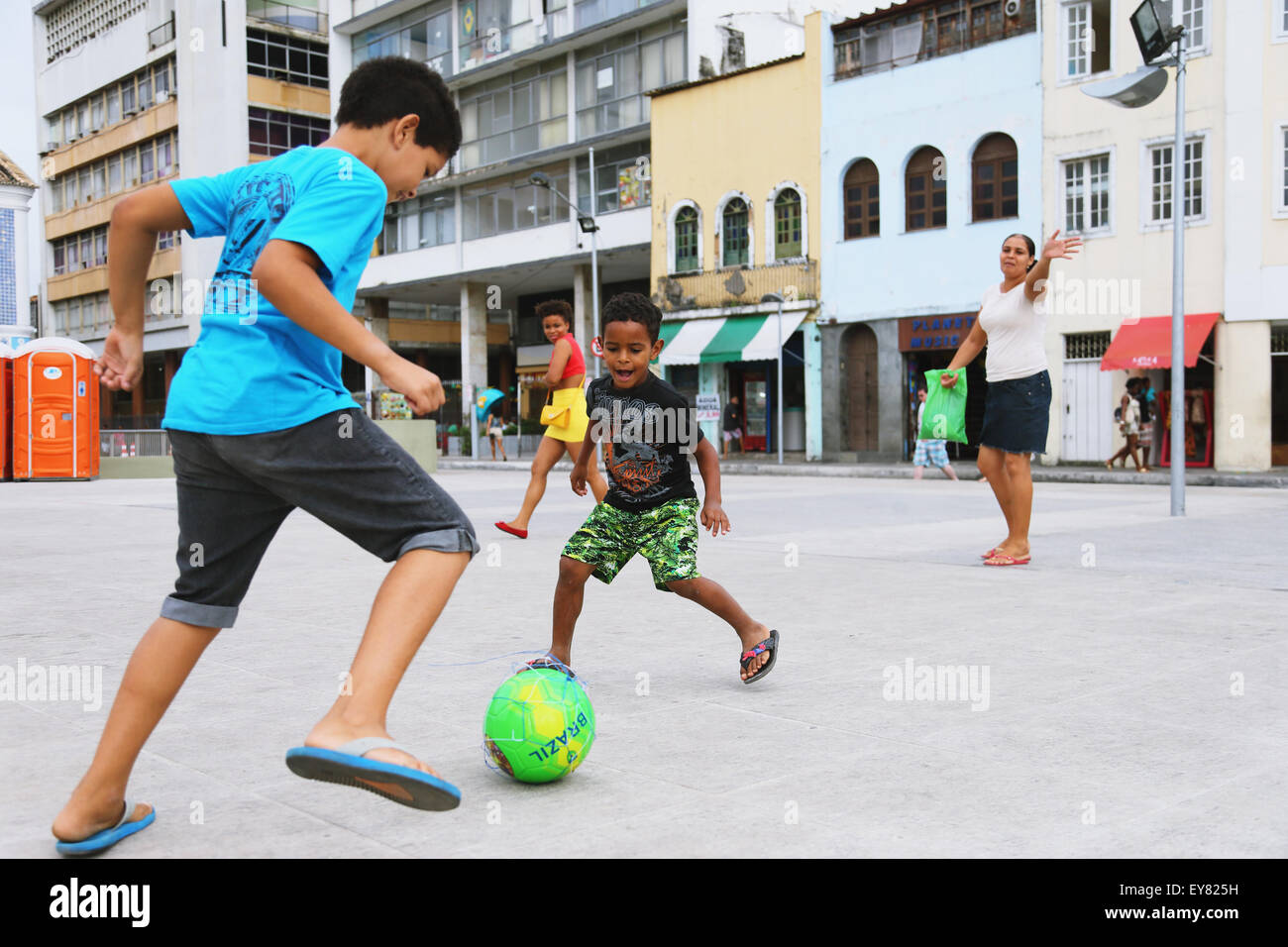 Kids playing soccer in the street, Brazil Stock Photo
