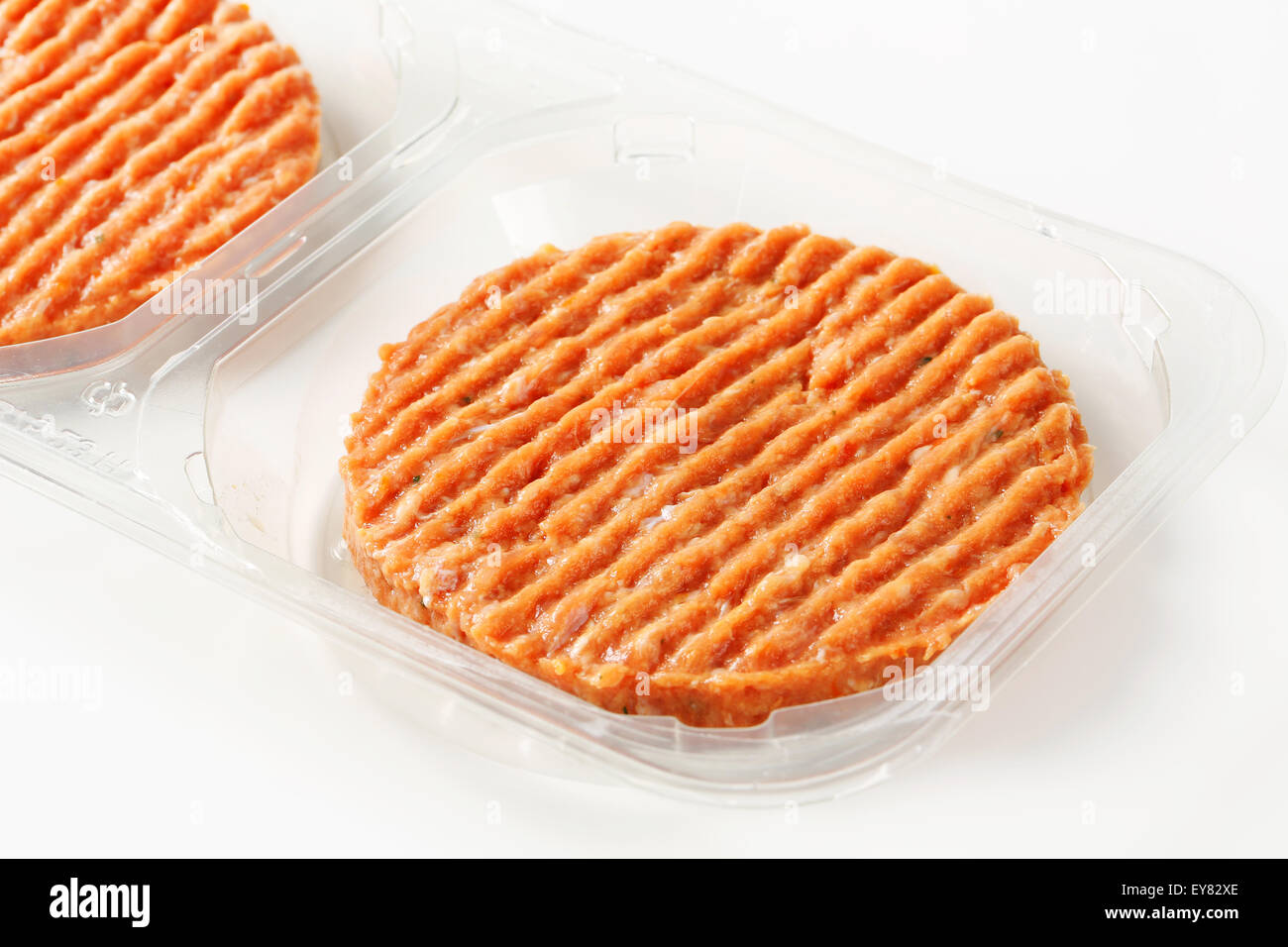 Raw burger patties in plastic packaging Stock Photo