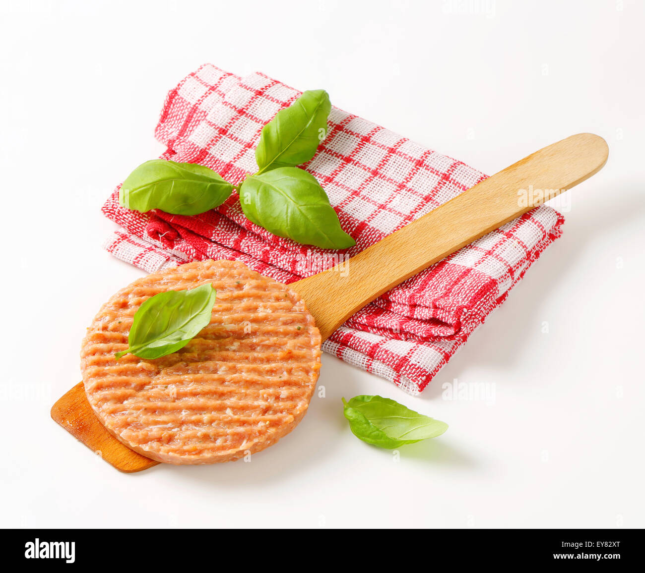Raw burger patty on wooden spatula Stock Photo