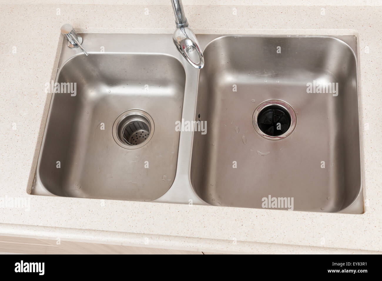 a double bowl stainless steel sink on kitchen counter Stock Photo