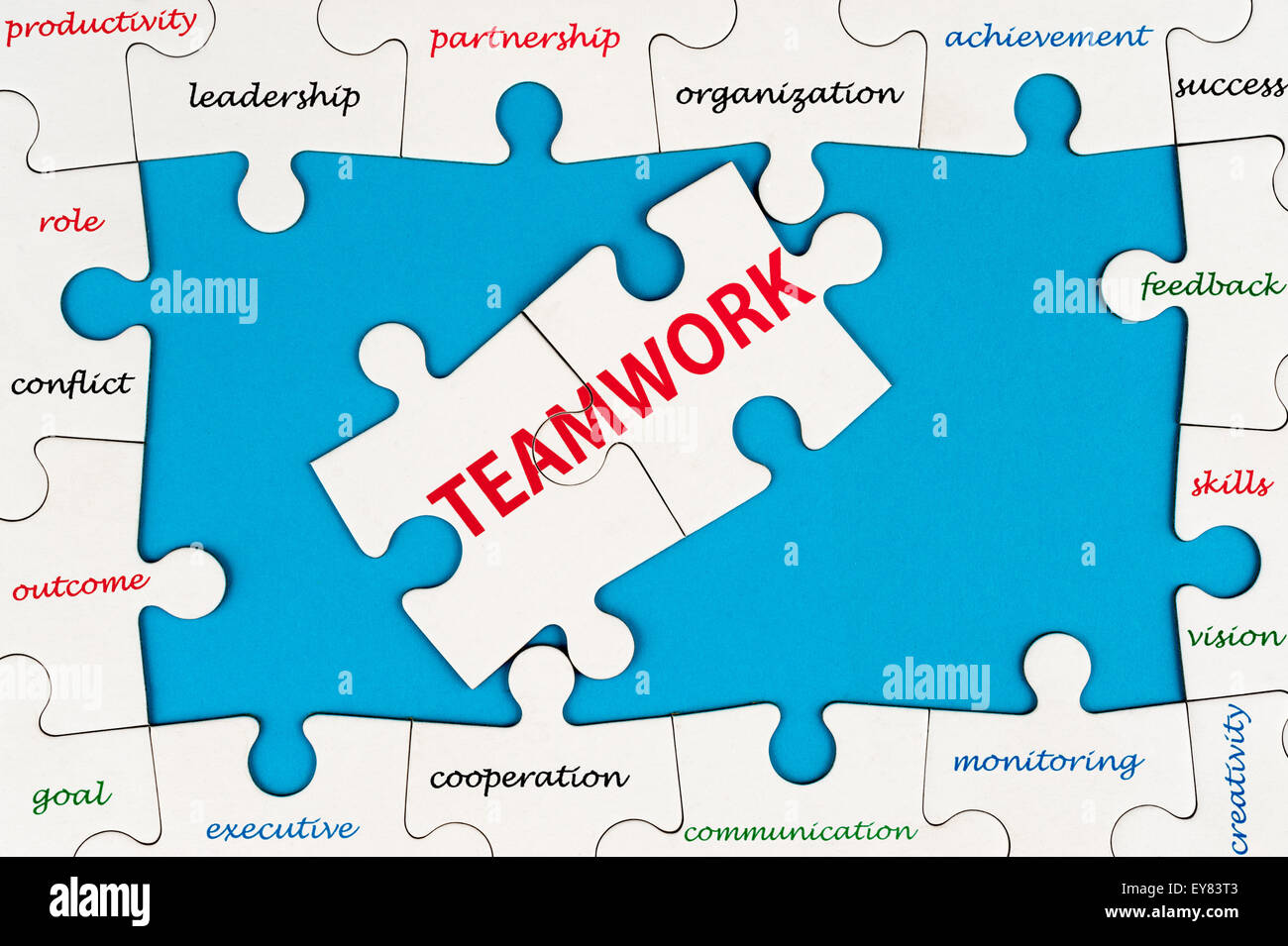 Teamwork concept word cloud on group of jigsaw puzzle pieces Stock Photo