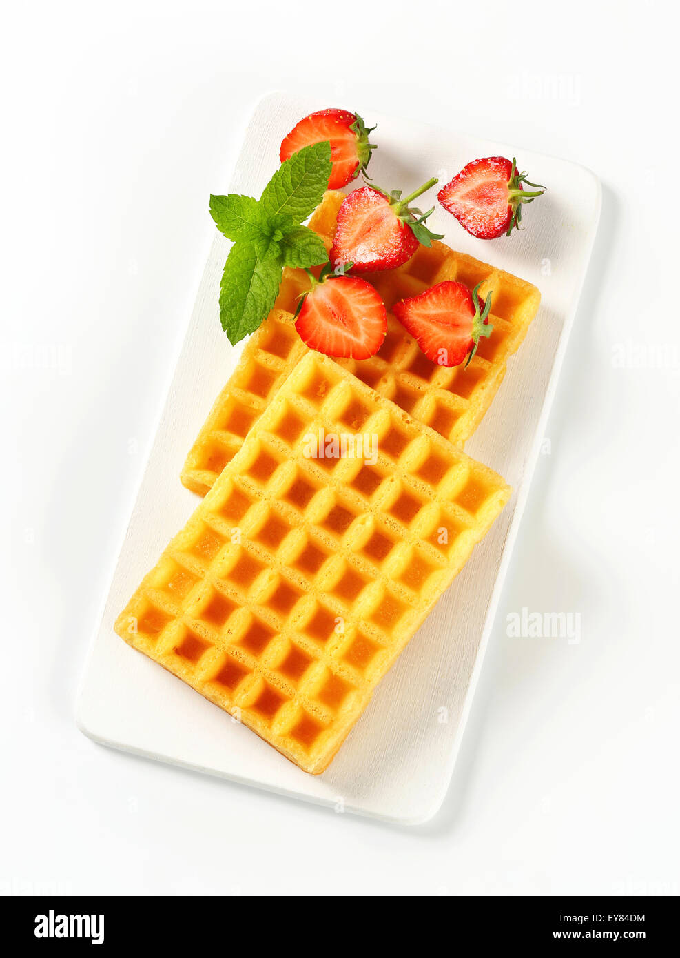 Studio shot of Belgian waffles and fresh strawberries Stock Photo