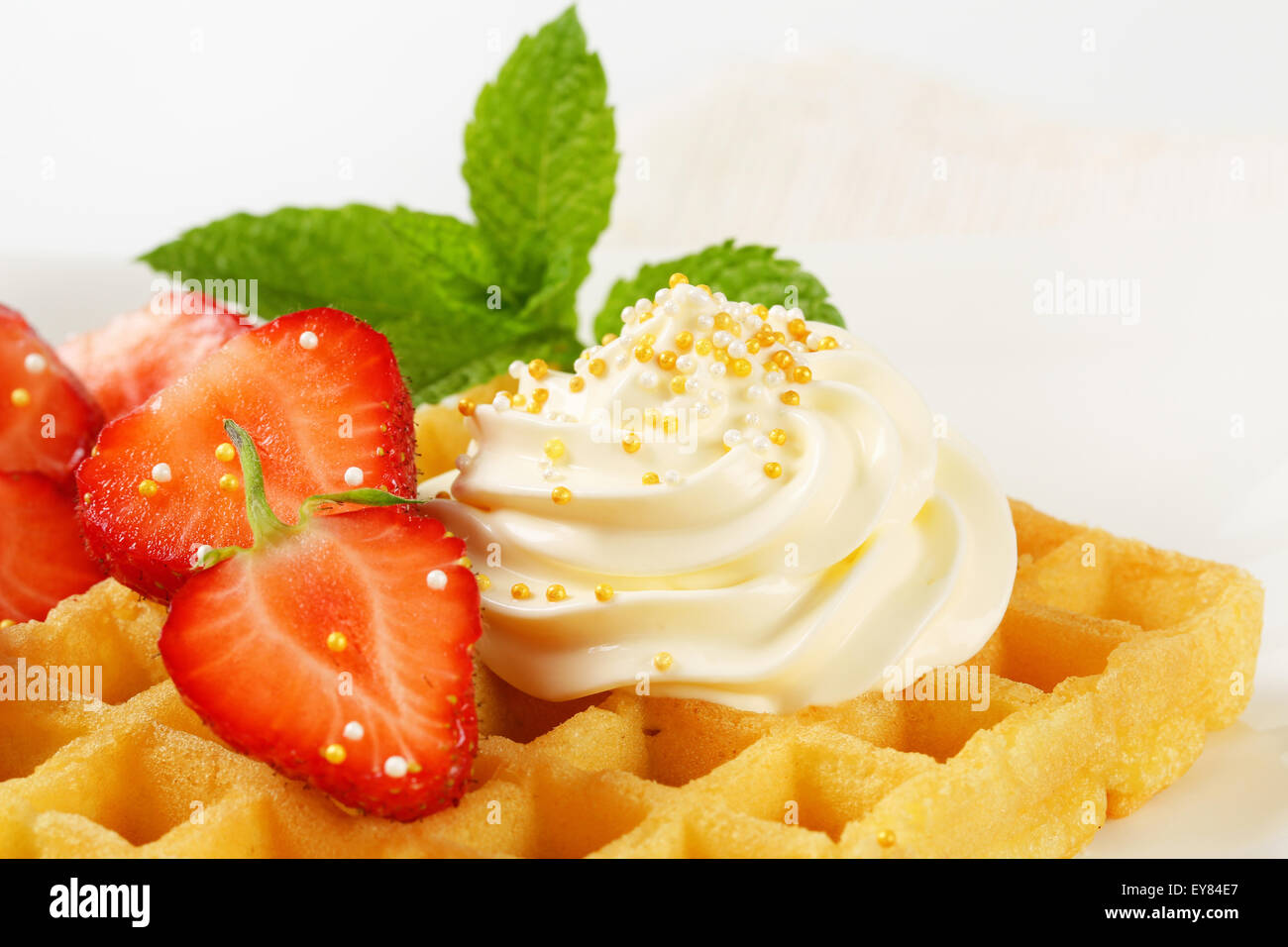 Belgian waffle with whipped cream and strawberries Stock Photo - Alamy