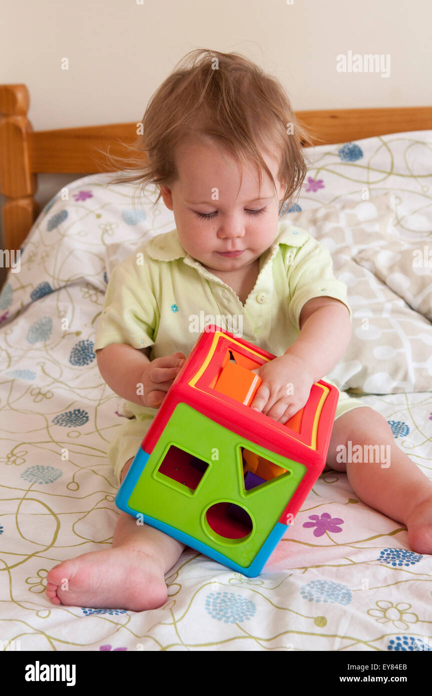 Baby playing inside with a shape sorter Stock Photo Alamy
