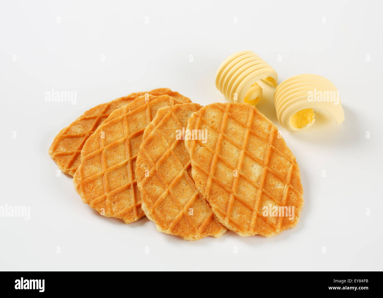 Thin waffle crisps and curls of fresh butter Stock Photo