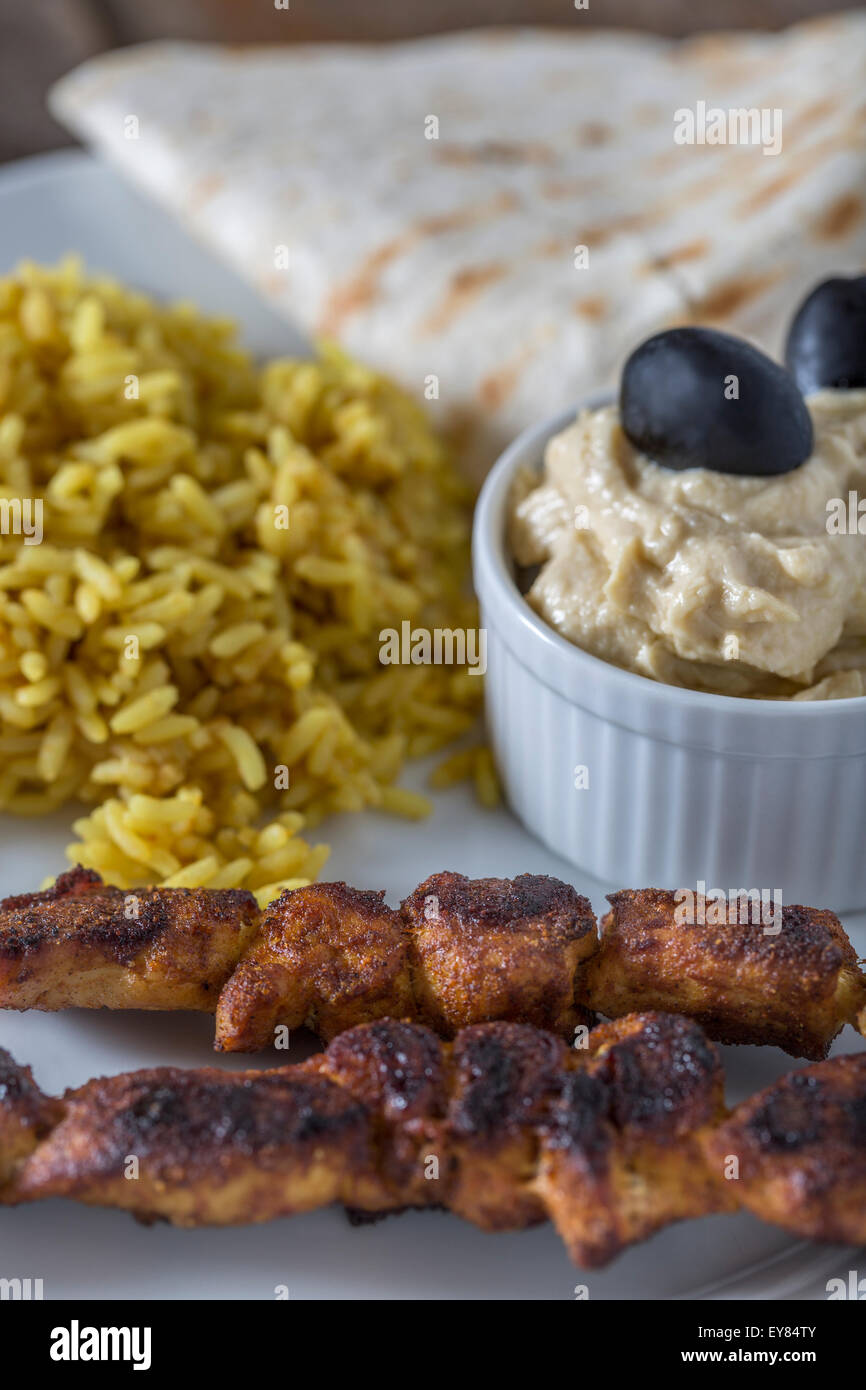 Plate with Kebab Hummus and Rice on wooden table Stock Photo Alamy