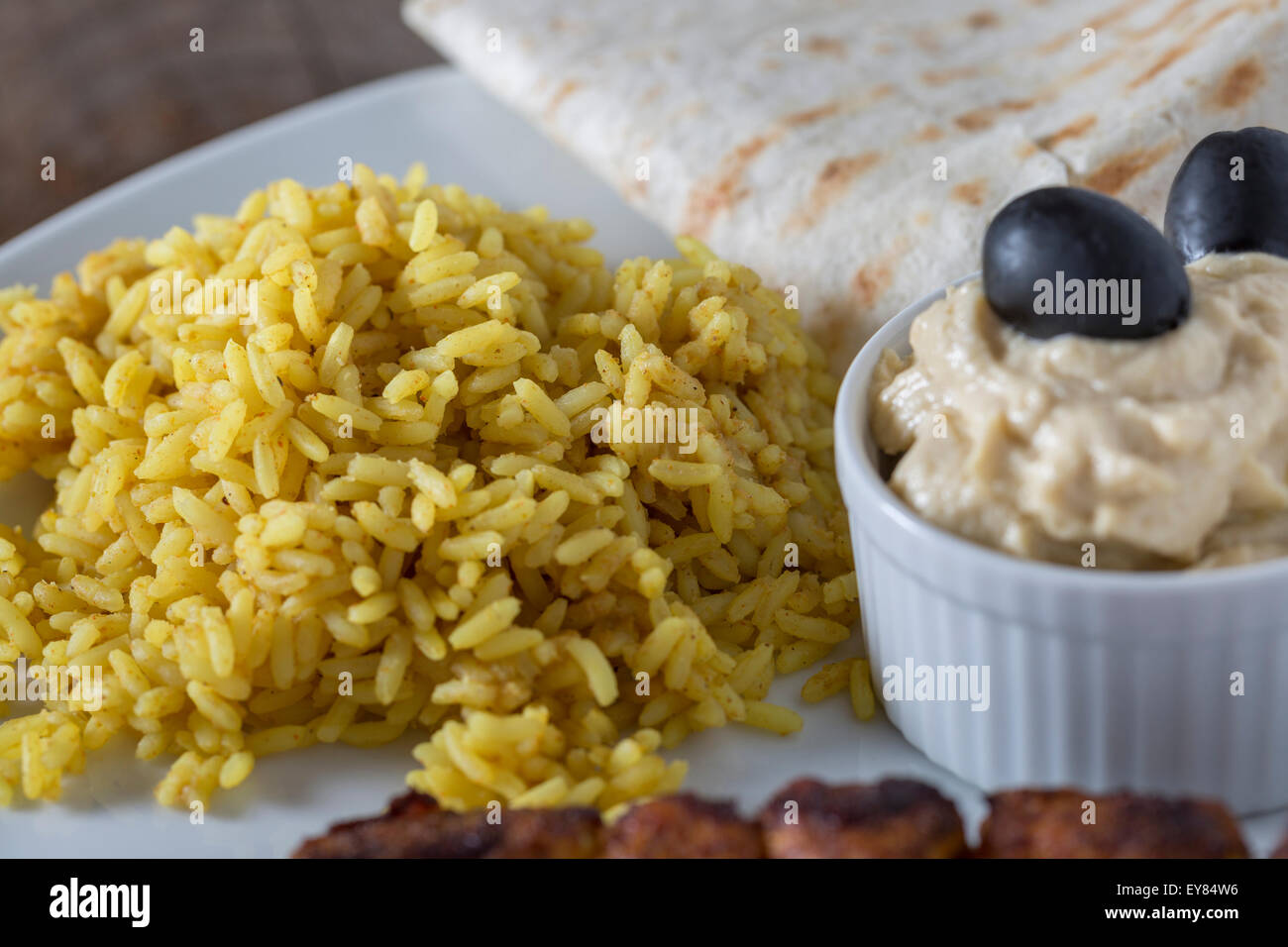 Plate with Kebab Hummus and Rice on wooden table Stock Photo Alamy