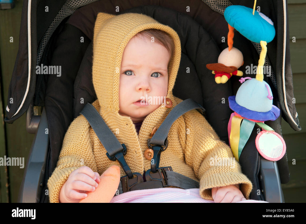Portrait of baby girl sitting in her pram Stock Photo Alamy
