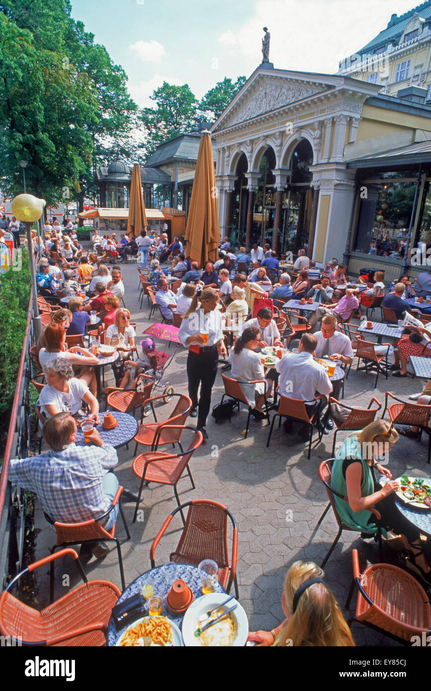 Summer tourists and activities around outdoor sidewalk restaurants near South Harbor in Helsinki, Finland Stock Photo