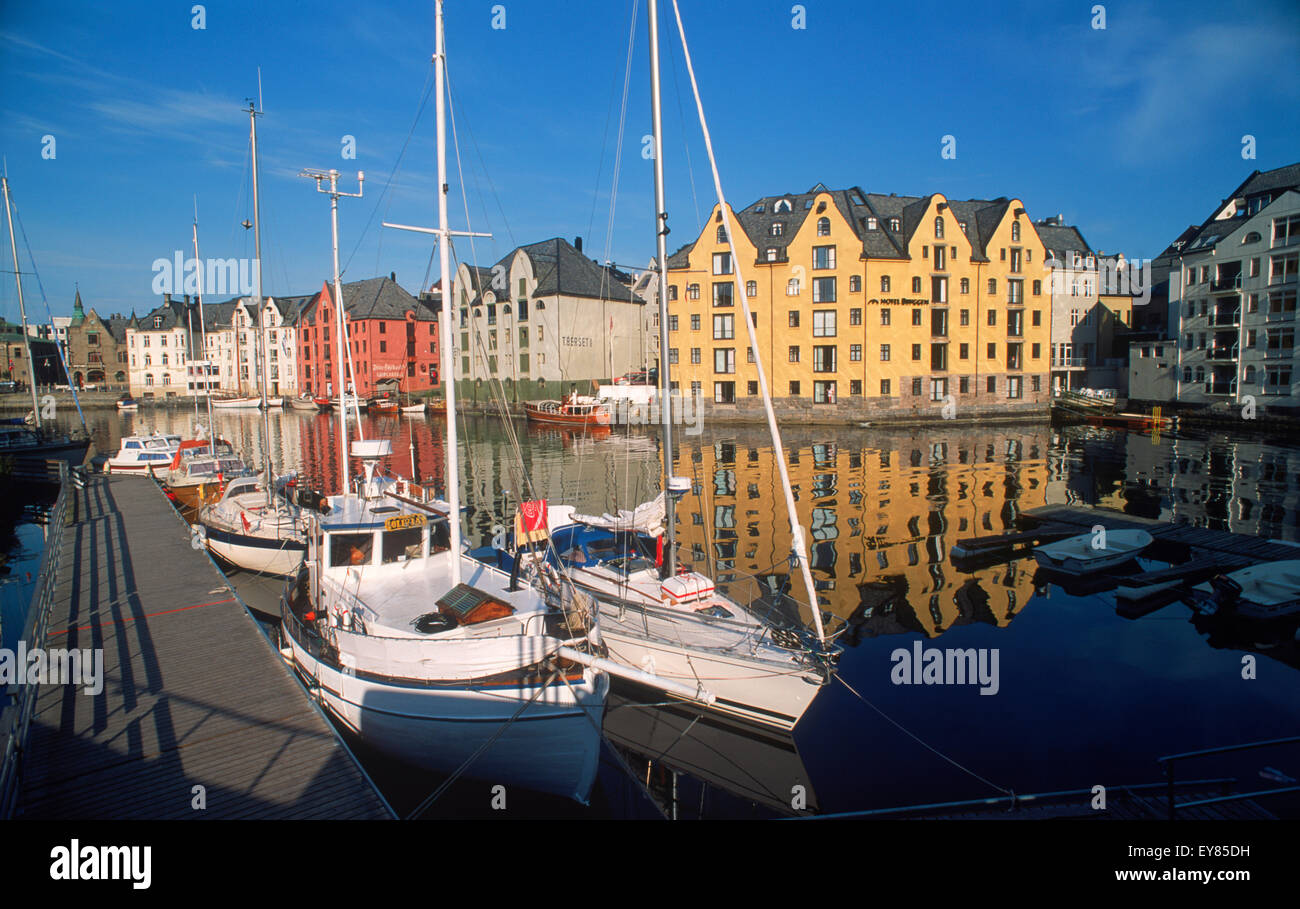 Apartments and boats along canal at sunrise in Ålesund, Norway Stock Photo