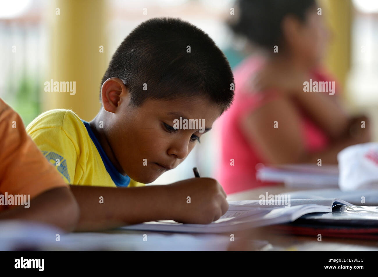 Pupil doing his homework, Puerto Maldonado, Madre de Dios department, Peru Stock Photo