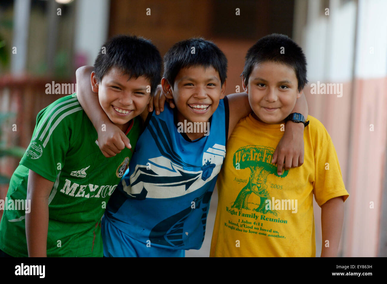 Three boys, friends embracing each other, Puerto Maldonado, Madre de Dios department, Peru Stock Photo