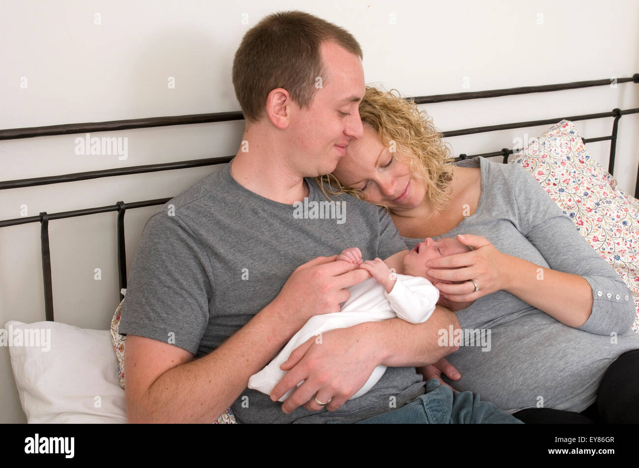 New Parents Holding Cuddling Their Newborn Baby Stock Photo Alamy