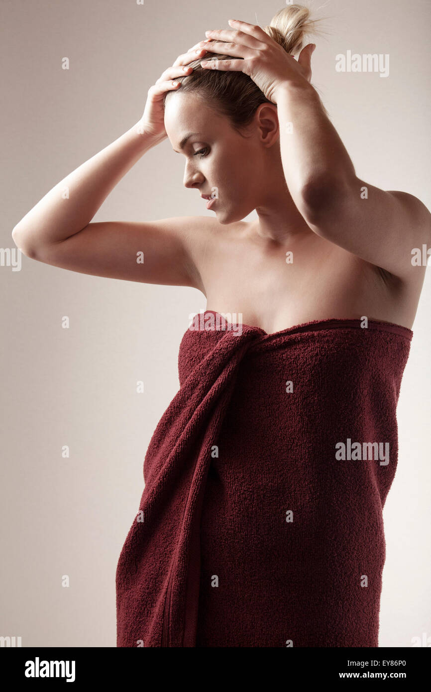 Young woman wrapped in towel Stock Photo - Alamy