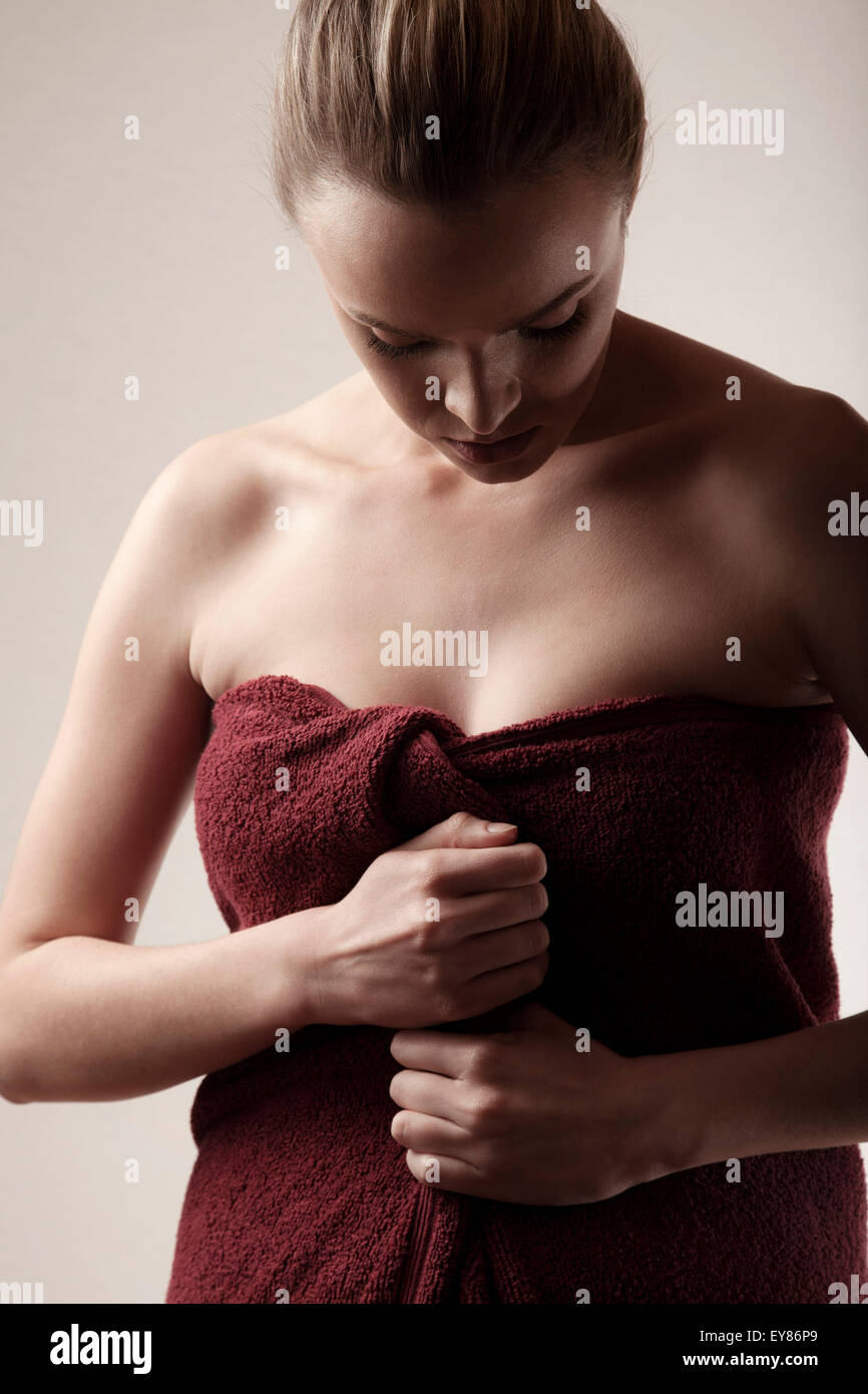 Young woman wrapped in towel Stock Photo