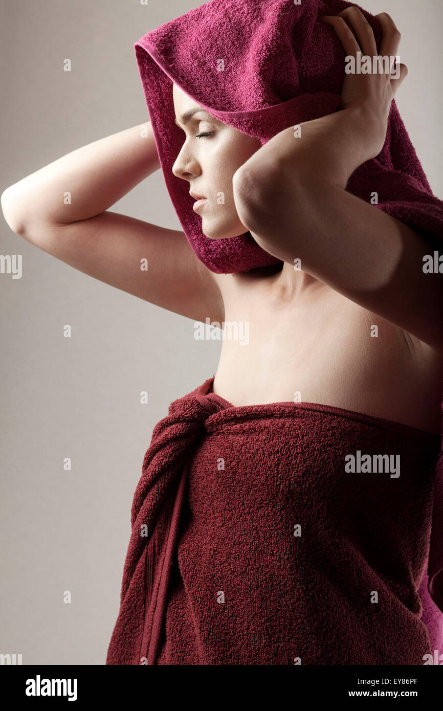 Young woman wrapped in towel Stock Photo - Alamy