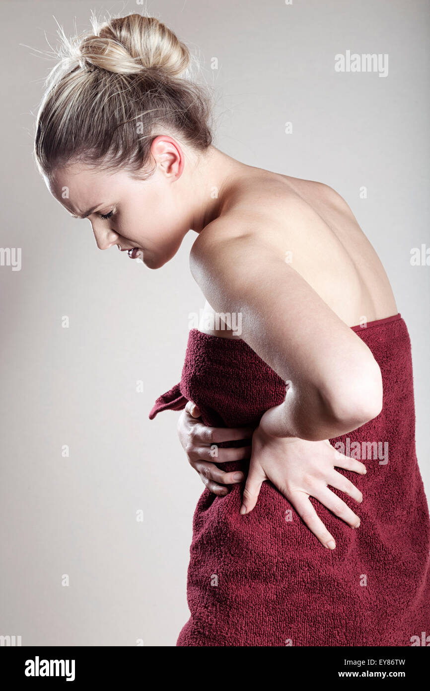 Young woman wrapped in towel Stock Photo