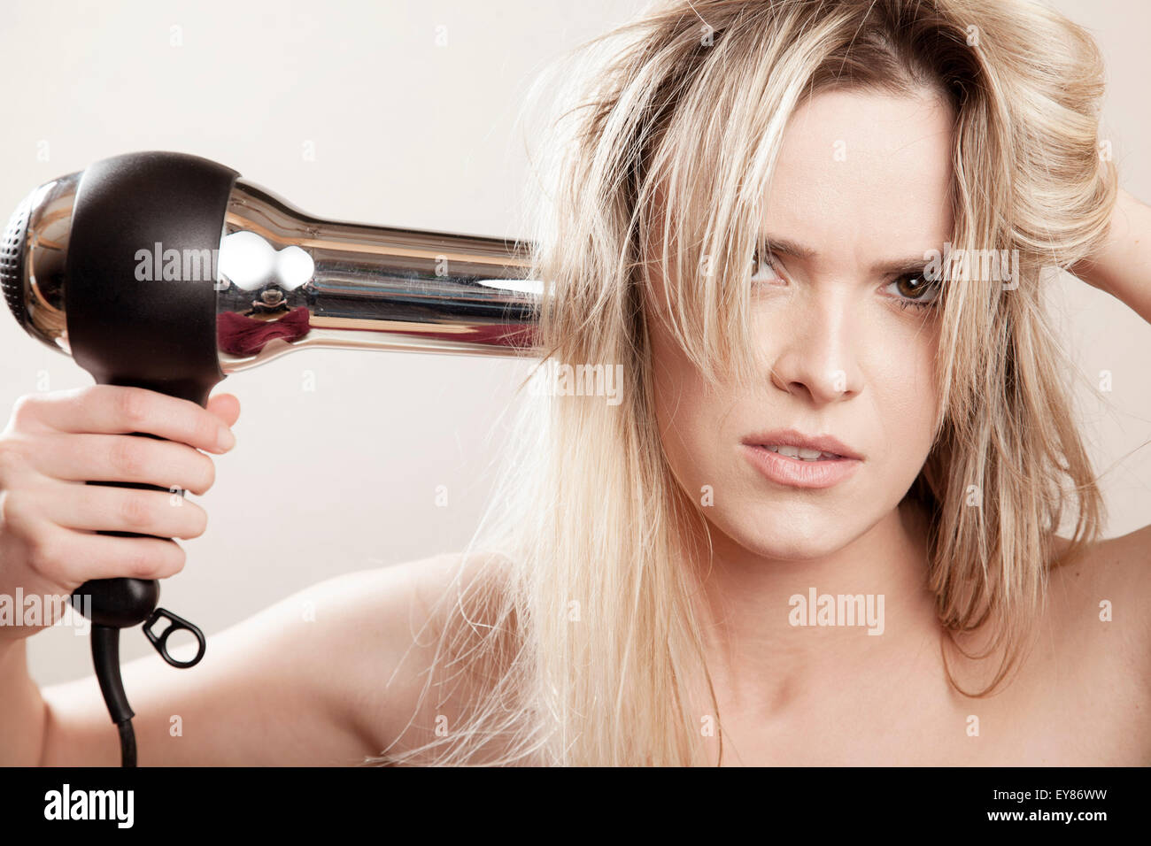 Young woman drying her hair Stock Photo Alamy