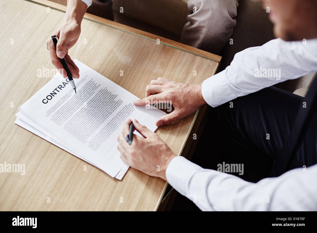 Hands of employees during discussion of contract Stock Photo - Alamy