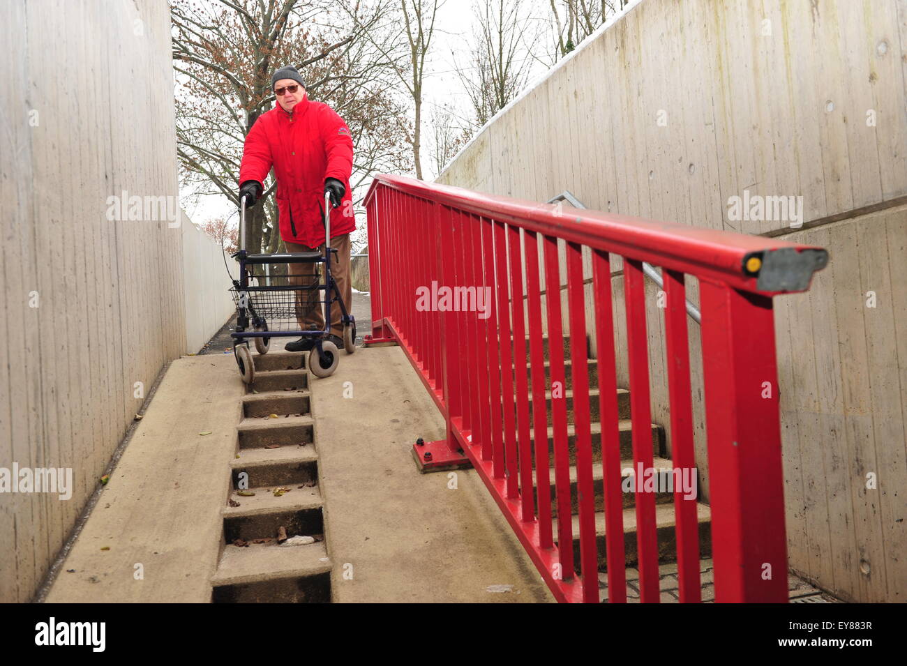 Worms, Germany - December 1, 2010: Old man having difficulties to move barrier-free though his city Stock Photo