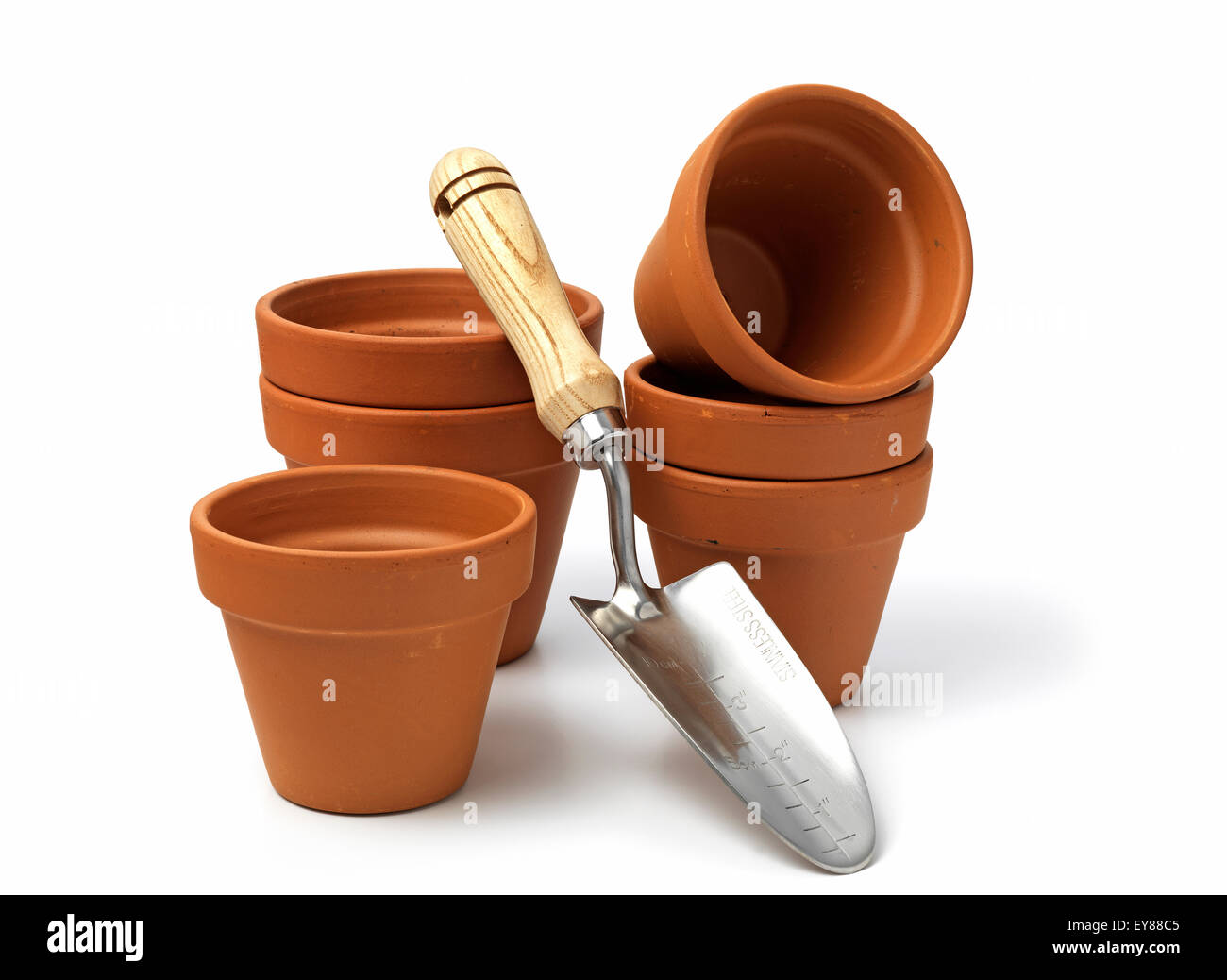 terracotta pots with a garden trowel isolated on a white background Stock Photo