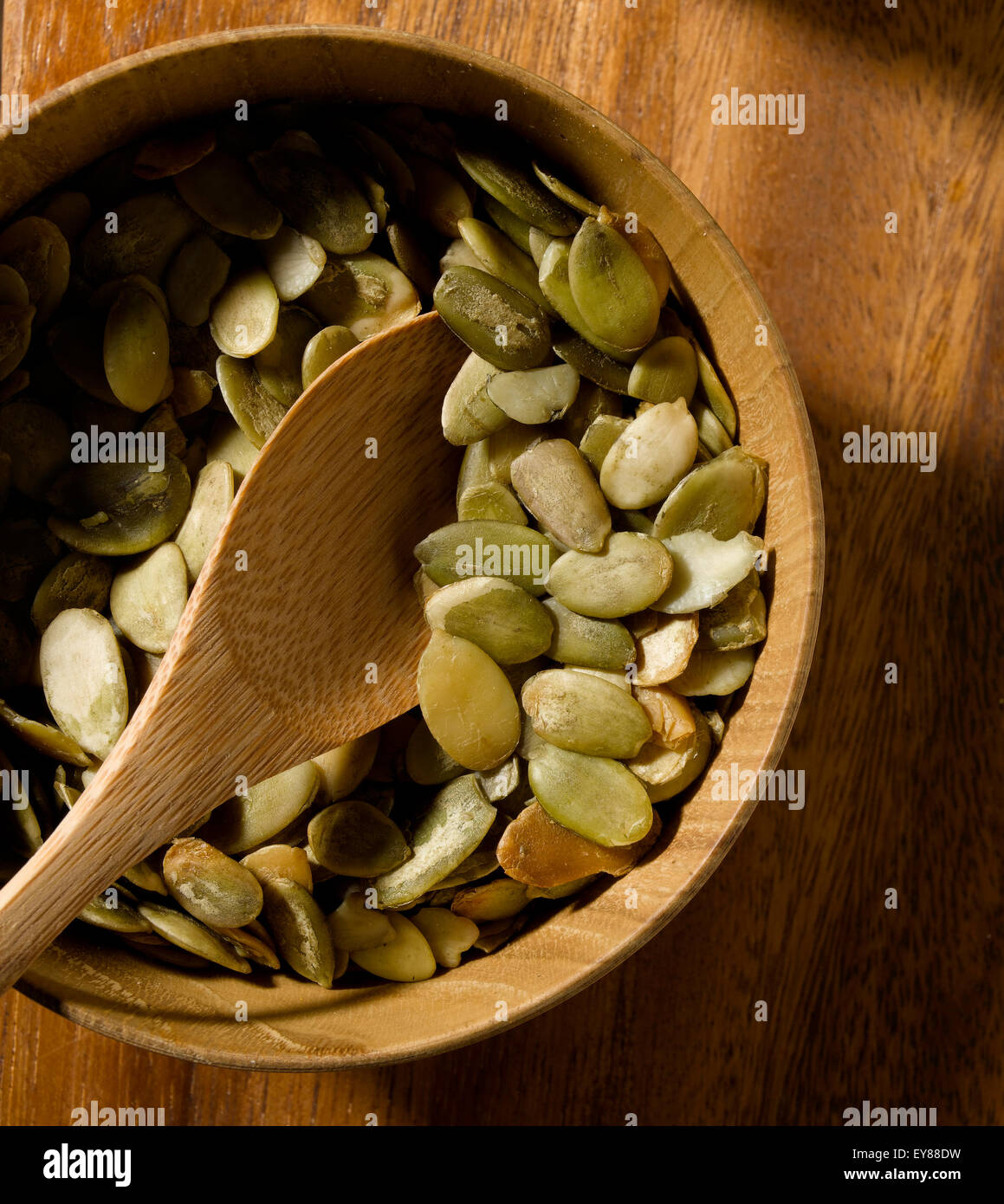 Pumpkin Seeds in bowl on tabletop Stock Photo