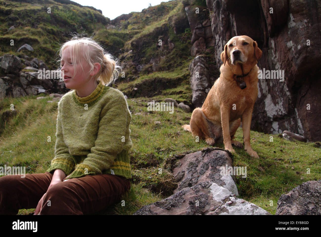 Young girl sitting outdoors with her labrador dog Stock Photo - Alamy