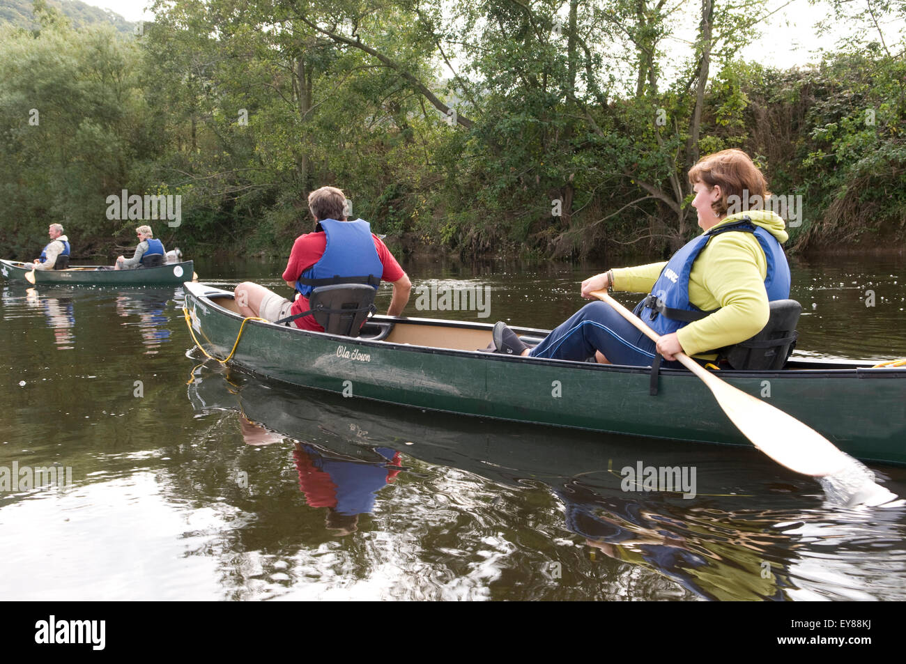 Rear view of people canoeing, wearing life jackets Stock Photo Alamy