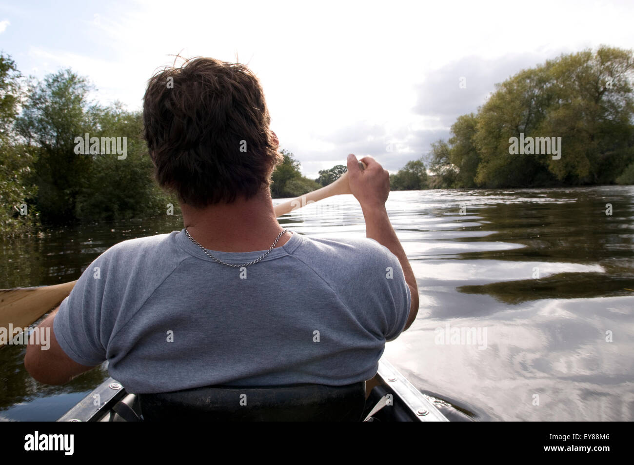 Rear view of man canoeing Stock Photo - Alamy