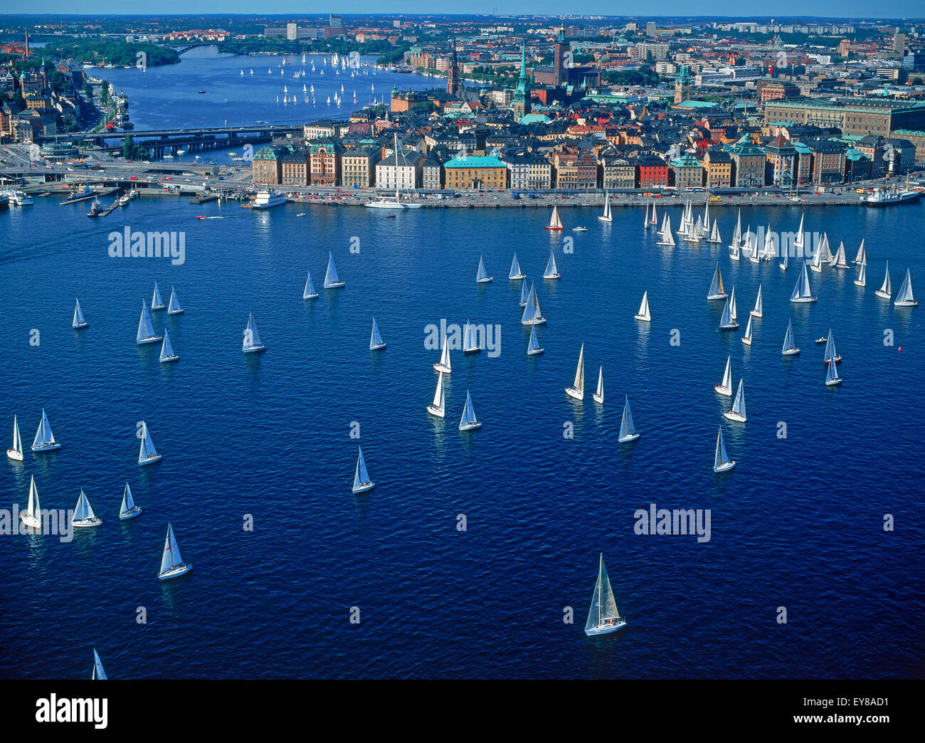 Aerial view of sailboats surrounding The Old Town of Stockholm during summer regatta on Saltsjön waters a bay of the Baltic Sea Stock Photo