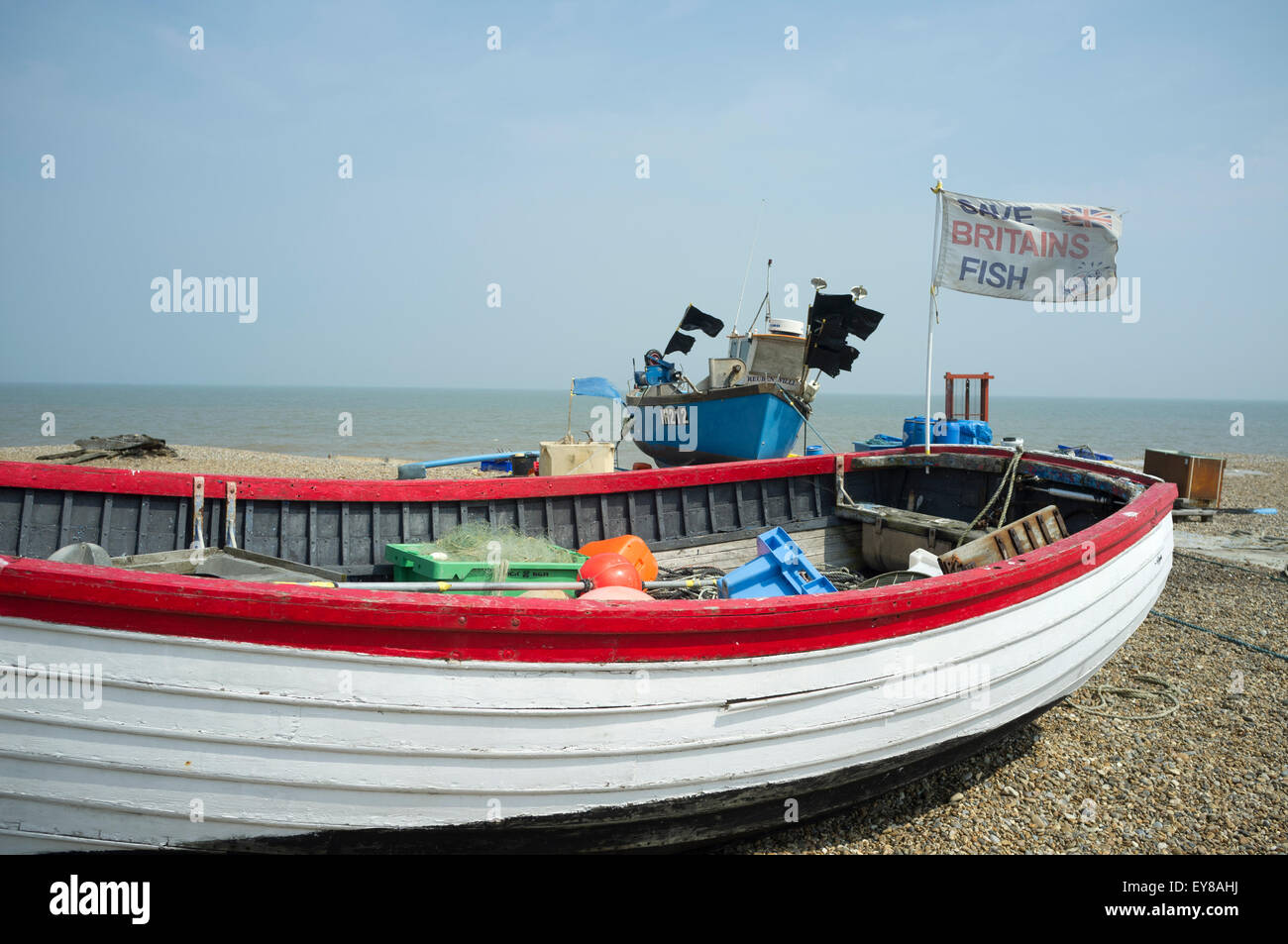 Fishing boats with flag flying with the words 'Save Britains fish', Aldeburgh, Suffolk, UK. Stock Photo