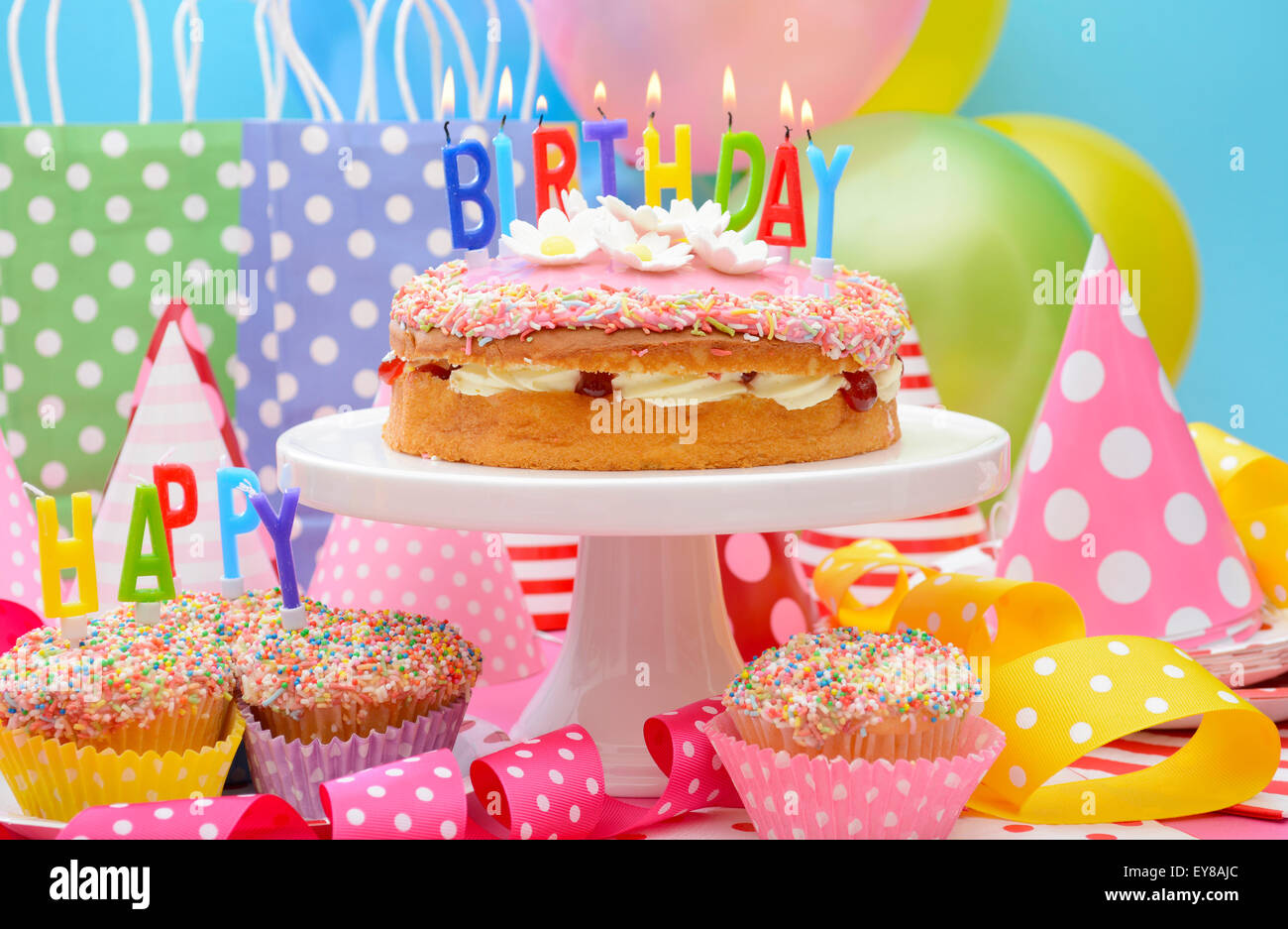 Happy birthday party cake streamers candles High Resolution Stock