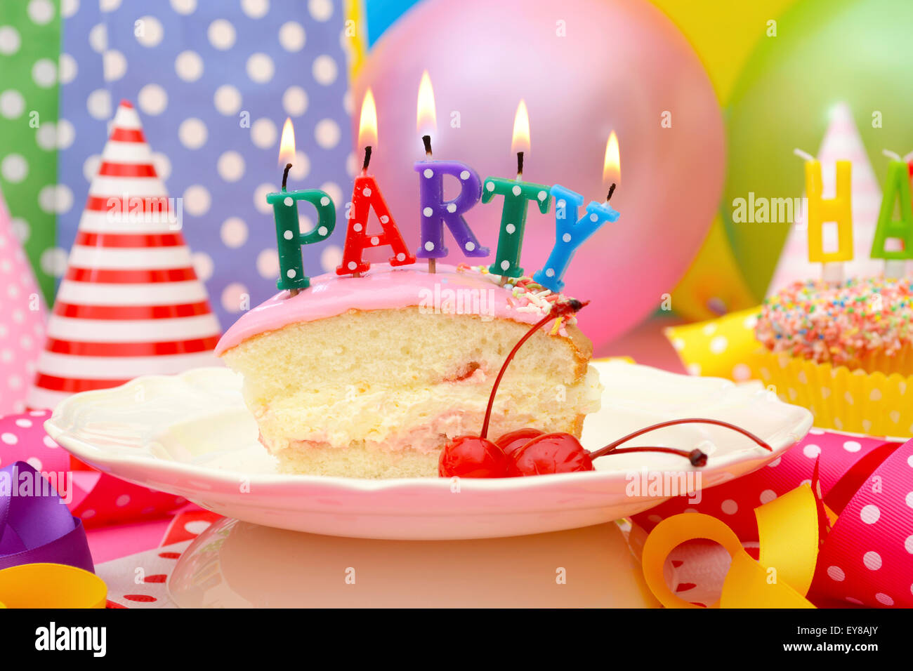 Happy birthday party cake streamers candles High Resolution Stock